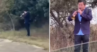 Yol kenarında zurna çalan bir Çinli görüntülendi